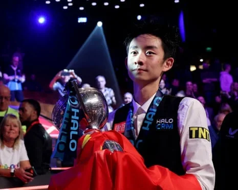 Wu Yize celebrates with the trophy