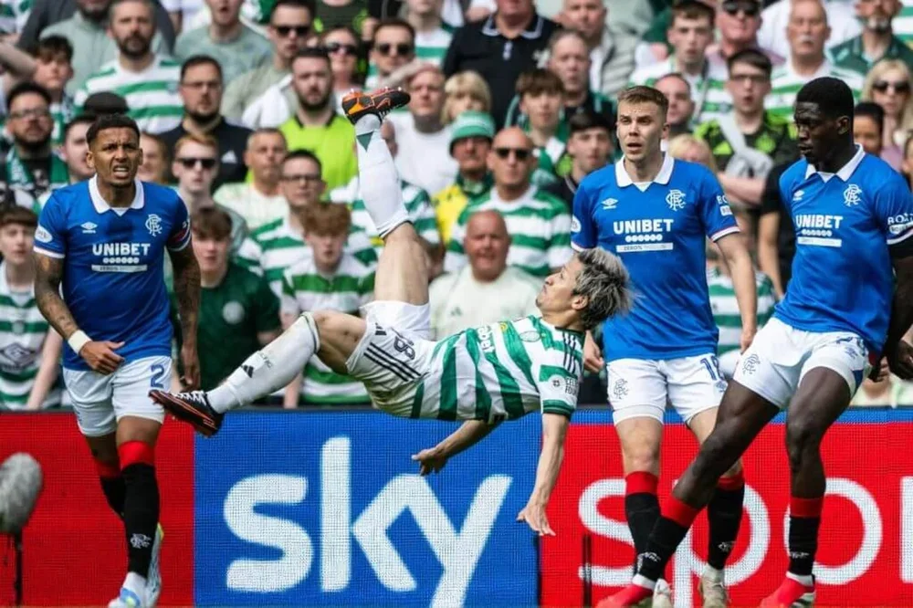 Daizen Maeda in mid-air after his overhead kick. Rangers players, in blue, watch on